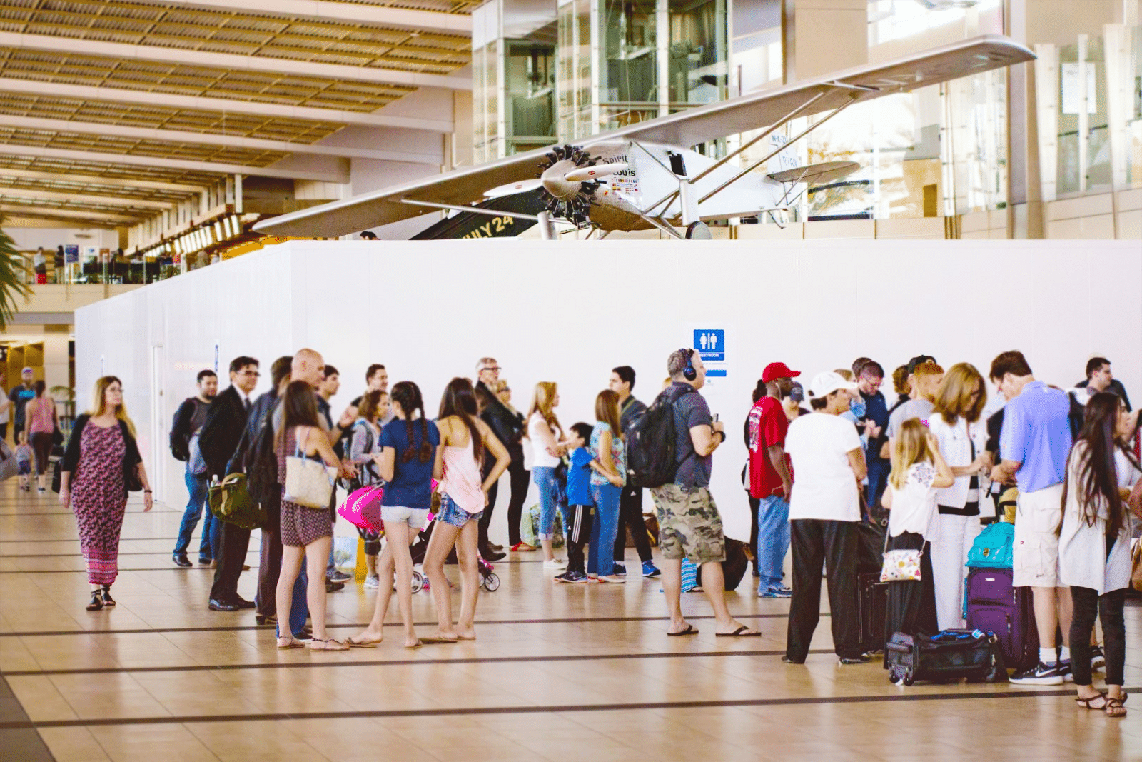 An image of a crowd of people walking around a temporary partition system from Swiftwall®.