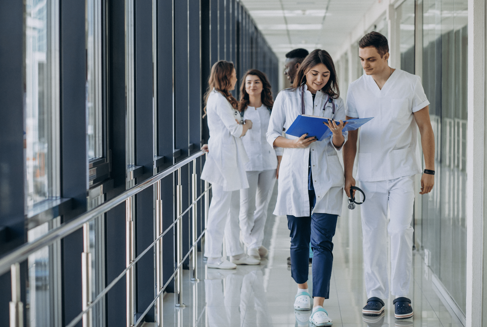 An image hospital staff walking down a hallway.